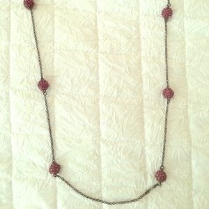 Long necklace with purply pink accent beads